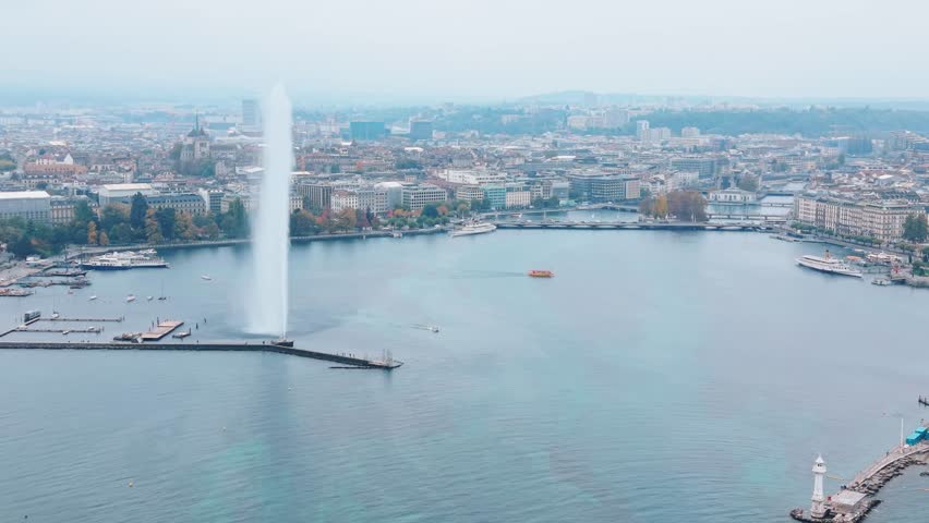 Aerial view of the iconic Jet d'Eau de Genève shooting skyward from the tranquil blue waters of Lake Geneva, Geneva, Switzerland.