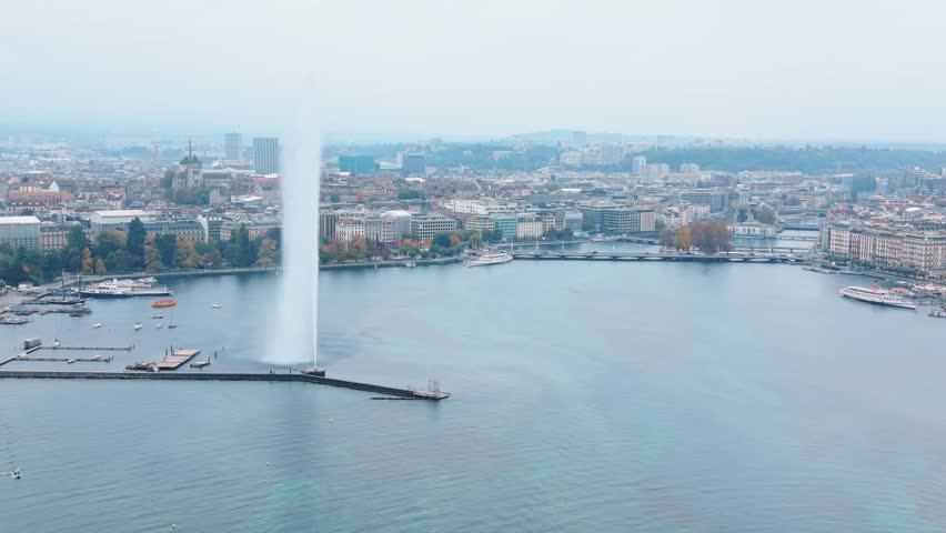 Aerial view of the iconic Jet d'Eau de Genève piercing the sky, contrasted against the tranquil waters of Lake Geneva, Geneva, Switzerland.