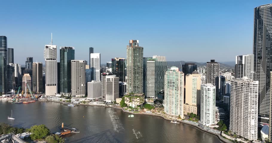 4K aerial pull out camera tracking view of the iconic Story Bridge and east side of Brisbane CBD with Brisbane River below where the CityCat ferries commute passengers, Brisbane, Queensland, Australia