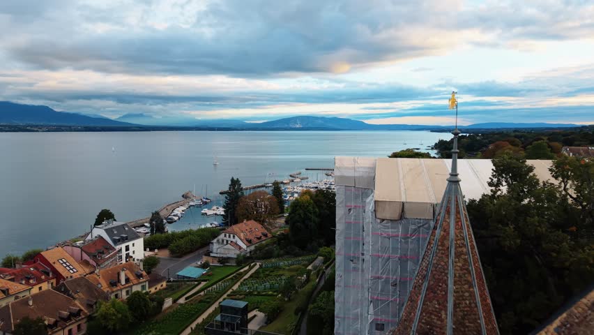 Aerial view of the medieval Nyon Castle, its white walls contrasting with the town