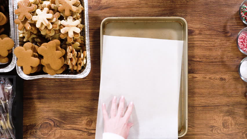 Flat lay. Preparing star-shaped cookies, half-dipped in chocolate, accented with peppermint chocolate chips for the holidays.