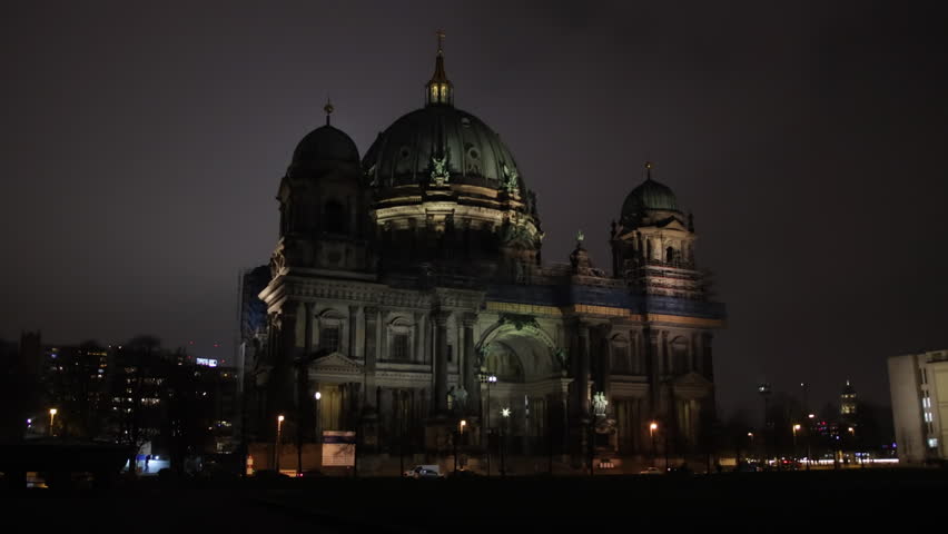 Gothic Architecture, Illuminated Facade, Cathedral Lights. Berlin Cathedral, lit up at night, contrasts starkly with dark sky above.