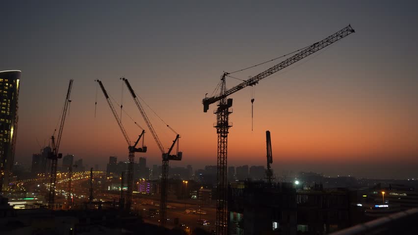 Construction Cranes Timelapse at Sunrise Over City Skyline