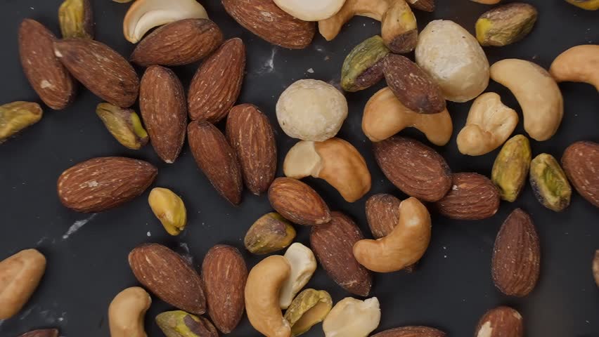 Premium blend of healthy, roasted mixed nuts featuring almonds, cashews, macadamias, and pistachios for a nutritious and delicious snack