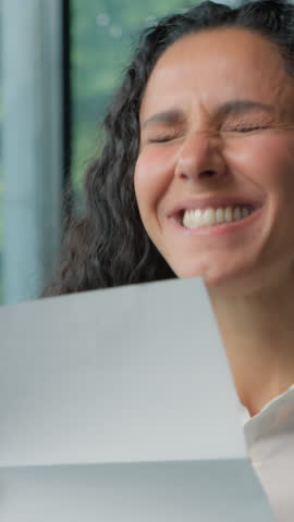 Hispanic business woman opening paper envelope reading good news amazed rejoice letter Arabian ethnic businesswoman female girl read information happy yelling joyful invitation bank credit approval