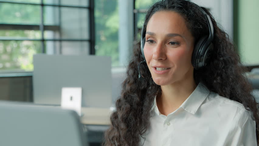 Happy smiling ethnic business woman talking video call e-learning distant education businesswoman talk in headphones conference studying online female girl coach mentor conversation with computer