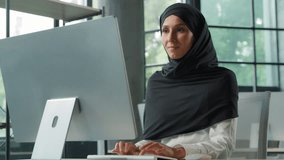 Arabian Muslim concentrated business woman in hijab working on computer in office Islamic businesswoman typing internet corporate software chatting with client smiling enjoying work female girl happy - Powered by Shutterstock - Get 15% off with code: PIKWIZARD15