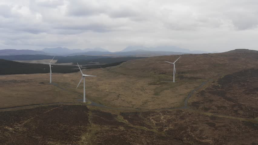 Wind farm in Scotland with turbines for electrical energy generation - Wind farm, power station for clean energy production from wind - Renewable energy and environment concepts