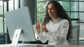 Hispanic business woman office worker talking video call with computer businesswoman showing with hands gesture explain work task e-learning talk conference online distant communication female girl - Powered by Shutterstock - Get 15% off with code: PIKWIZARD15