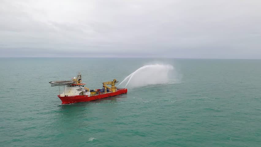 Supply ship testing fire fighting water canons for mergency responce on oil platforms