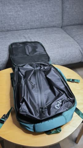 Vertical close-up of hands opening and organizing a modern backpack. Clean lifestyle setup — ideal for product ads, travel packing scenes, and minimalist brand visuals.