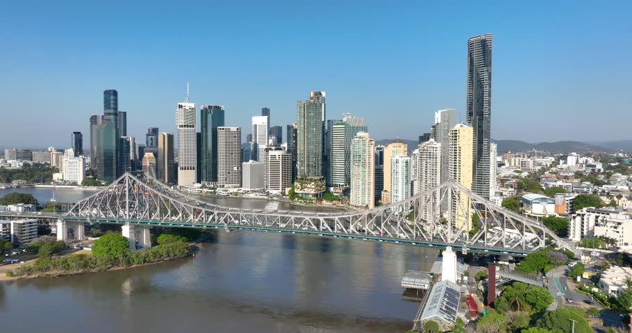 4K aerial right to left pan tracking view of the iconic Story Bridge and east side of Brisbane CBD with the Brisbane River below where CityCat ferries commute passengers,Brisbane,Queensland, Australia