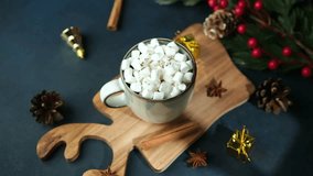 Warm mug of cocoa with marshmallows on wooden board, cinnamon sticks and pine cones - Powered by Shutterstock - Get 15% off with code: PIKWIZARD15