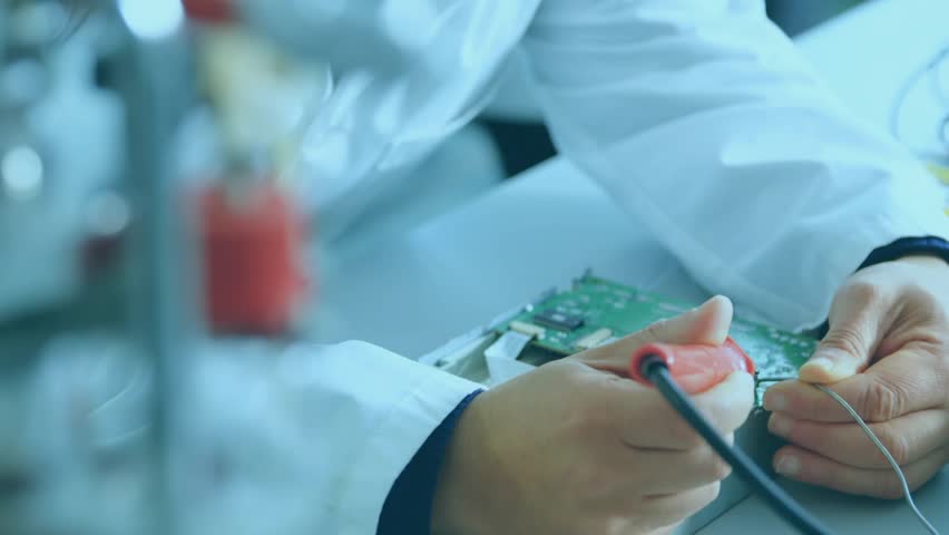 Mid adult male technician soldering circuit board in tech lab, map overlay growing hazard icons. Technology, electronics, innovation, engineering, cybersecurity, data, connectivity - Powered by Shutterstock - Get 15% off with code: PIKWIZARD15