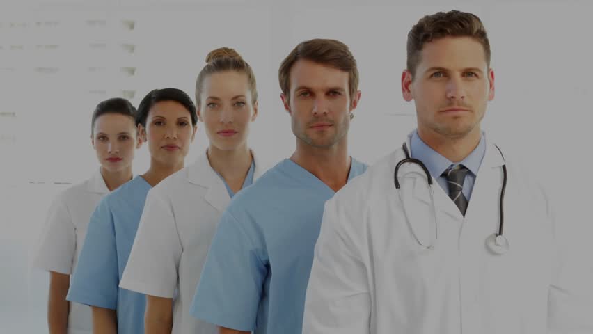 Medical team standing, financial charts sweeping across, doctor turning visualizing health trends. Healthcare, teamwork, professionalism, data visualization, digital analytics, clinical - Powered by Shutterstock - Get 15% off with code: PIKWIZARD15