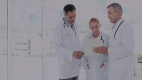 Senior doctor speaking to colleagues in hospital, transparent chart projecting data nurses pointing. Medical professionals, collaboration, technology, data analysis, innovation, teamwork, healthcare - Powered by Shutterstock - Get 15% off with code: PIKWIZARD15