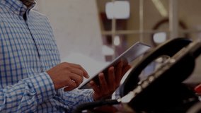 Man tapping tablet screen, swiping controls in tech workspace, animated icons guiding adjustments. Technology, innovation, digital, business, workspace, interface, management - Powered by Shutterstock - Get 15% off with code: PIKWIZARD15