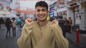 Man shows hands raising concern on street as young hispanic male stands in outdoor road public area. - Powered by Shutterstock - Get 15% off with code: PIKWIZARD15