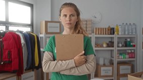 Woman with clipboard holding station in warehouse, a blonde young volunteer managing donation boxes on shelves. - Powered by Shutterstock - Get 15% off with code: PIKWIZARD15