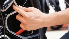  A specialist repairs a dent on the car body without painting. PDR. Process of paintless dent repair on car body. The mechanic at the auto shop with tools to repair dents in car body. Body repair. - Powered by Shutterstock - Get 15% off with code: PIKWIZARD15