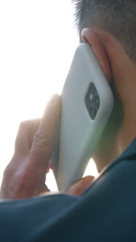 Back view business man talking mobile phone calling answer call discuss work businessman talk smartphone speak Asian Korean male entrepreneur busy with telephone negotiation unknown agent in city