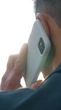 Back view business man talking mobile phone calling answer call discuss work businessman talk smartphone speak Asian Korean male entrepreneur busy with telephone negotiation unknown agent in city - Powered by Shutterstock - Get 15% off with code: PIKWIZARD15