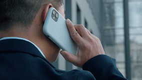 Back view unrecognizable Asian business man talking mobile phone businessman talk smartphone call communicate formal corporate negotiation unknown male conversation in city negotiate work job discuss - Powered by Shutterstock - Get 15% off with code: PIKWIZARD15