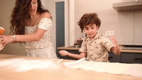 Parent and young child bonding while kneading dough together, spreading white flour across kitchen counter, sharing culinary moment of learning and joy - Powered by Shutterstock - Get 15% off with code: PIKWIZARD15