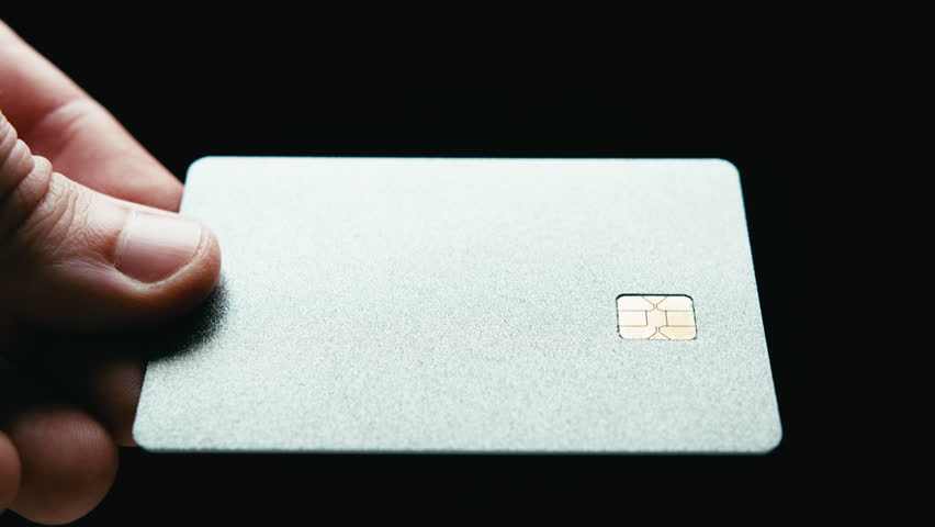 Reflective gray credit card on black background during Black Friday sales