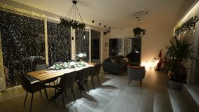 A beautifully decorated dining room is ready for a Christmas celebration, with lights and festive decor - Powered by Shutterstock - Get 15% off with code: PIKWIZARD15