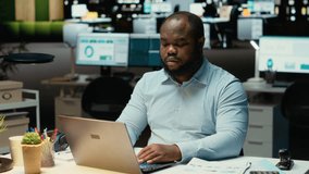 African american employee working at night proofreading web information, writing important data on laptop. Creating a summary and designing strategy to align with enterprise targets. Camera B. - Powered by Shutterstock - Get 15% off with code: PIKWIZARD15