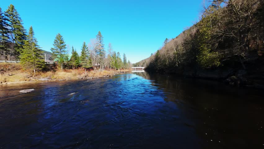 sunny lake between mountain ridges in quebec