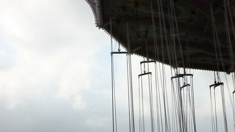 Abstract Swinging People at Amusement Park Outdoors