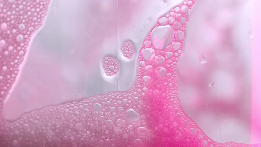 Pink soap bubbles Background. Foam Water Soap Suds Texture. Pink foam macro background. 4k footage