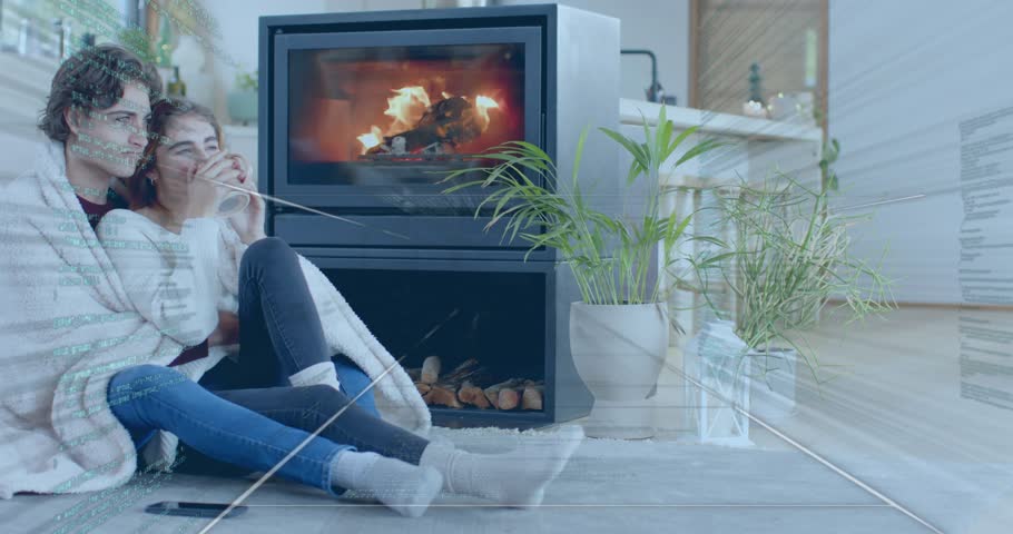 Couple snuggling under blanket beside stove woman reaching mug sipping warmth showing decor ideas. Cozy, intimacy, relaxation, warmth, comfort, modern, minimalistic