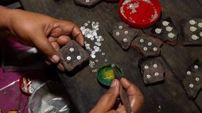 A silversmith arranges tiny silver pieces by hand in Celuk, Bali, Close up - Powered by Shutterstock - Get 15% off with code: PIKWIZARD15