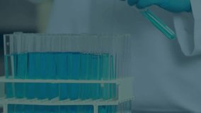 Gloved hand lifting, rotating test tube from lab rack to visualize particle swirl in blue solution. Science, laboratory, experimentation, chemistry, research, innovation, precision - Powered by Shutterstock - Get 15% off with code: PIKWIZARD15