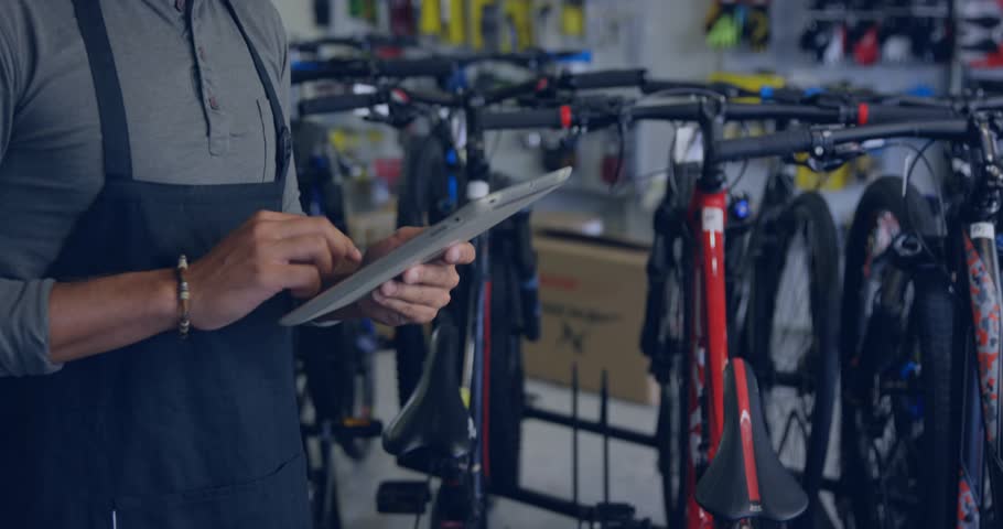 Bike shop associate tapping tablet and activating badge icons tracking sales before dispersing. Technology, digital, innovation, commerce, user interface, retail, modern