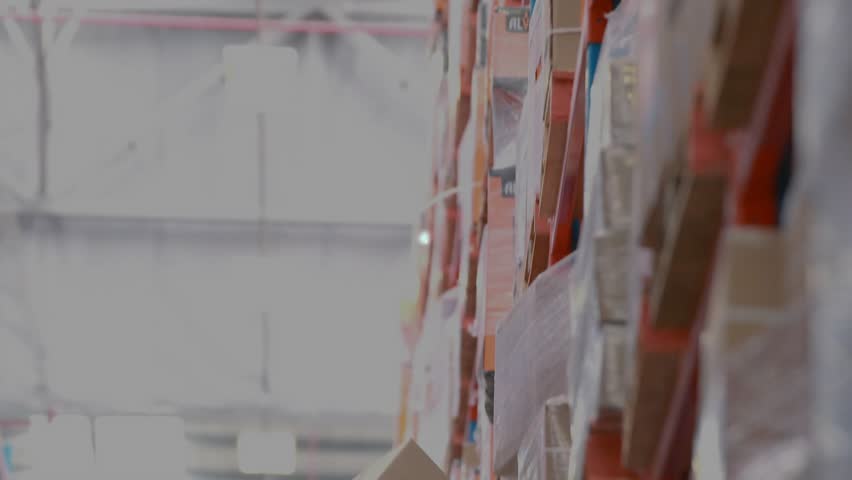Warehouse worker pulling box from shelf, initiating digital network overlay for inventory tracking. Logistics, supply chain, technology, industrial, automation, inventory, connectivity - Powered by Shutterstock - Get 15% off with code: PIKWIZARD15