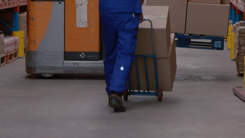 Warehouse worker pushing pallet jack past forklift while data overlay tracking inventory movement. Logistics, automation, productivity, industrial, technology, efficiency, storage - Powered by Shutterstock - Get 15% off with code: PIKWIZARD15