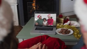 Couple sitting starting technology greeting remote family as emoji reactions swirling around laptop. Festive, holiday, celebration, virtual, pandemic, cozy, connection - Powered by Shutterstock - Get 15% off with code: PIKWIZARD15