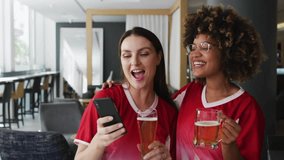 Two friends at bar tapping smartphone reacting and causing emoji spheres swirling around drinks. Friendship, celebration, technology, entertainment, social, vibrant, casual - Powered by Shutterstock - Get 15% off with code: PIKWIZARD15