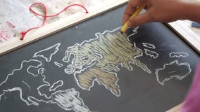 Child drawing a world map on a chalkboard 4k - Powered by Shutterstock - Get 15% off with code: PIKWIZARD15