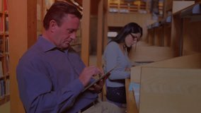 Man tapping tablet and woman typing notes at library, circuits emerging to visualize education data. Technology, education, research, digital, innovation, focus, collaboration - Powered by Shutterstock - Get 15% off with code: PIKWIZARD15