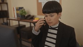 Woman talking on phone in modern office with computer expressing frustration and determination in workplace indoor setting. - Powered by Shutterstock - Get 15% off with code: PIKWIZARD15