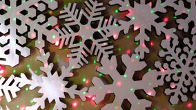 Wooden carving snowflakes on a dark wall with multicolored lights, LED,  glowing, sparkling. Ball lightning. Festive New Year card. Copy space. Mock up - Powered by Shutterstock - Get 15% off with code: PIKWIZARD15