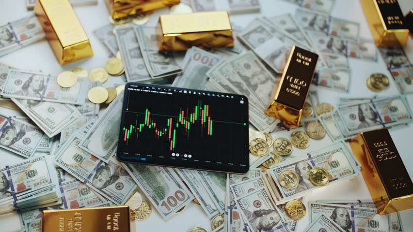Modern tablet with live candlestick chart surrounded by scattered hundred-dollar bills, gold coins and bars, symbolizing wealth, digital trading and investment success