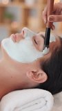 Skincare, hands and woman with face mask at spa for facial treatment, deep cleansing or self care. Relax, client and beauty therapist with clay product application for exfoliation, bokeh and pamper - Powered by Shutterstock - Get 15% off with code: PIKWIZARD15