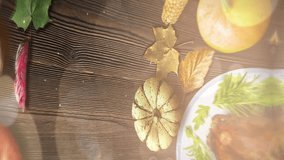 Overhead shot of a Thanksgiving table with turkey, pumpkins, apples, and autumn leaves. Preparing for a festive holiday dinner. - Powered by Shutterstock - Get 15% off with code: PIKWIZARD15