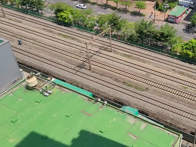 High-Speed Train Passing Through Seoul City Railway from Above

